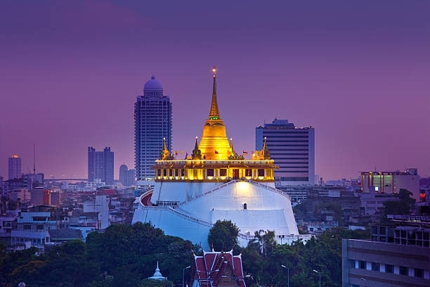 Climb the stairs to Wat Saket.